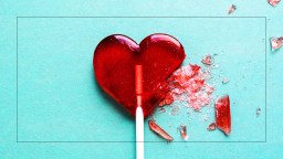 A broken heart lollipop on a blue background.