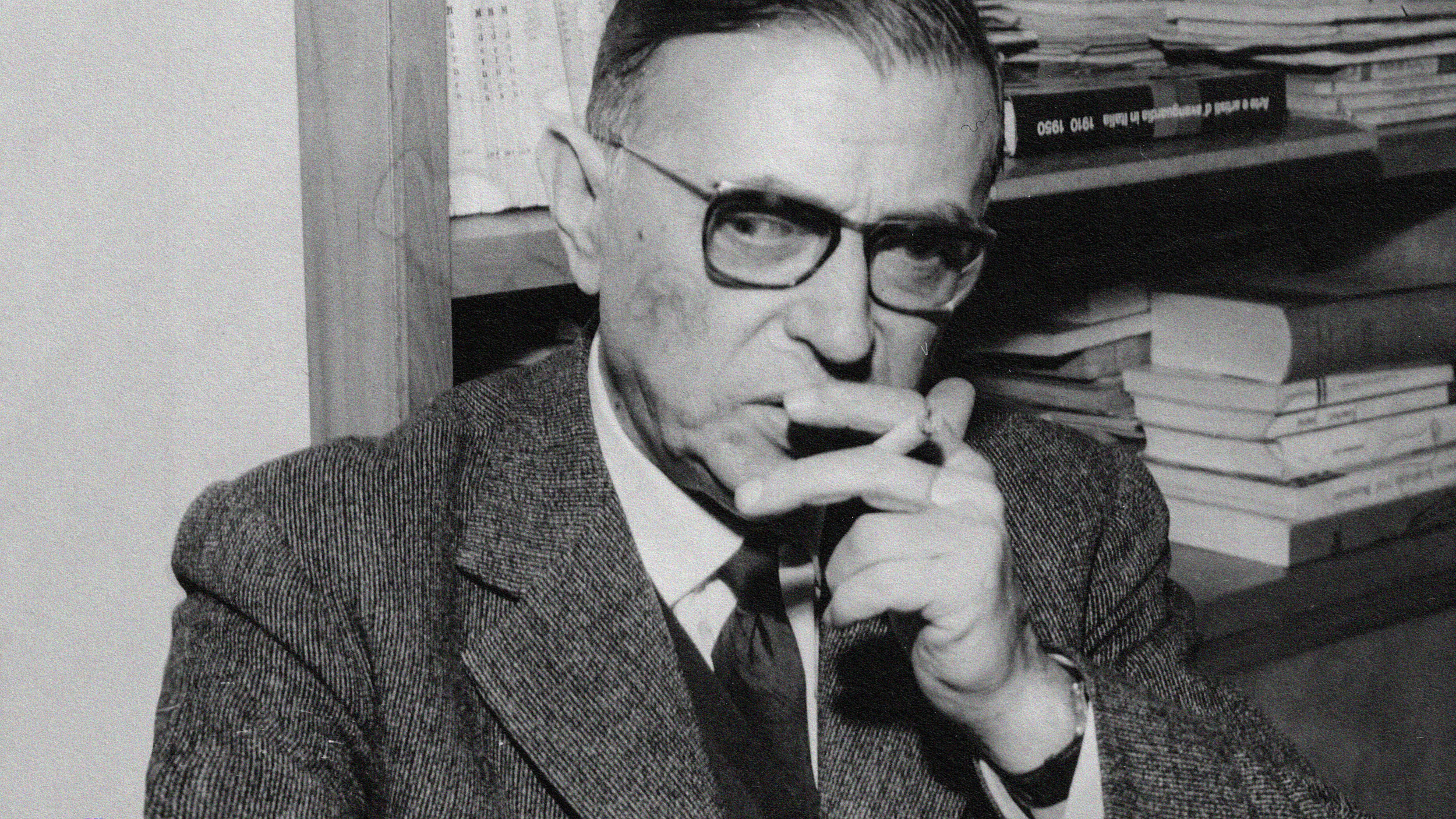 An old black and white photo showing a man smoking a cigarette.