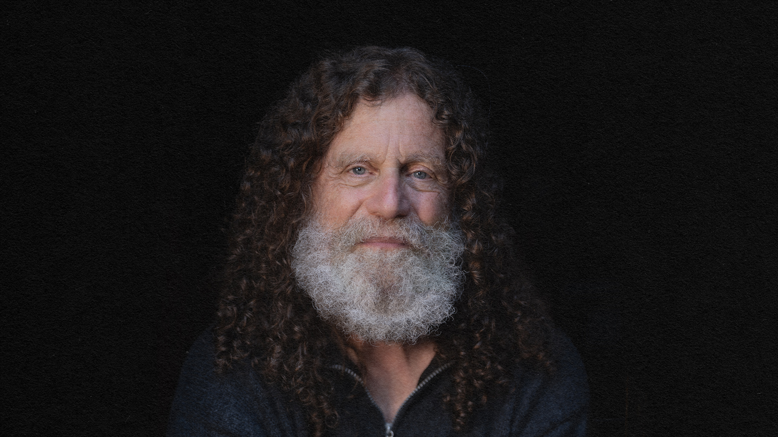 A man with long hair and a beard, embodying the concept of free will.